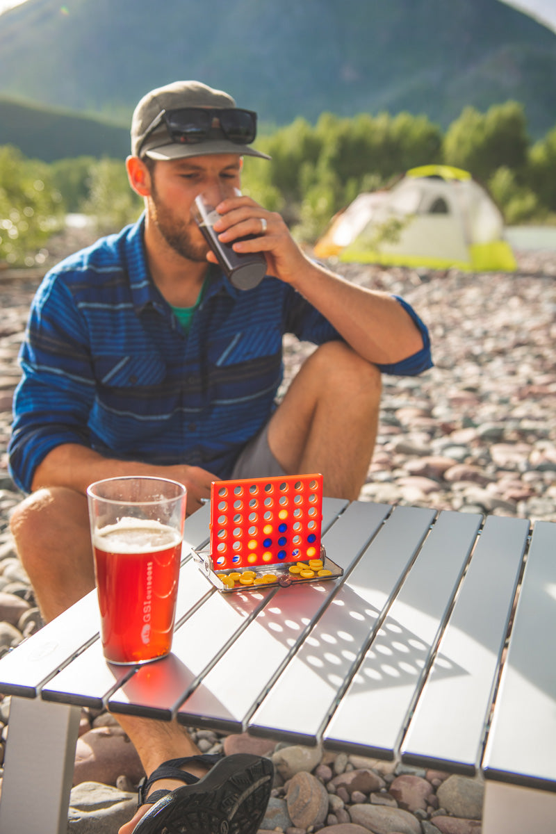 Cheers to playing Connect Four on the beach.